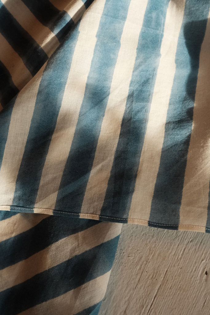 Indigo blue and white vertical striped cotton bandana by World of Crow, handwoven in India using natural dyes and traditional weaving techniques – sustainable unisex accessory for everyday wear.