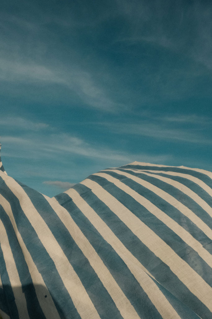 Indigo blue and white vertical striped cotton bandana by World of Crow, handwoven in India using natural dyes and traditional weaving techniques – sustainable unisex accessory for everyday wear.