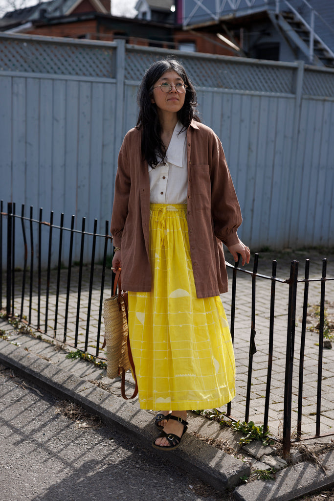 Indulge in the timeless appeal of this artist smock, tailored for both artists and creatives, as well as individuals seeking a stylish layer for their ensemble. The rich rusty brown hue adds a distinctive touch, seamlessly complementing any outfit for an elevated look. Featuring full sleeves, button closure, and a convenient front pocket, this smock offers both practicality and sophistication in one.